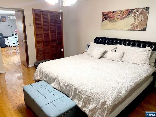 bedroom with hardwood / wood-style floors and a closet