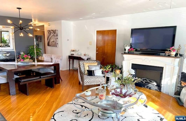 living room with light hardwood / wood-style floors and a chandelier