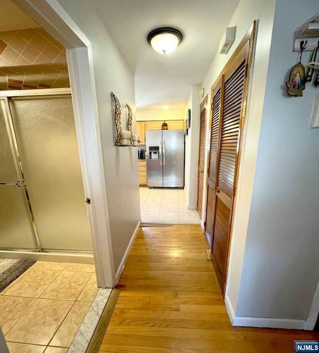 hall with light hardwood / wood-style floors