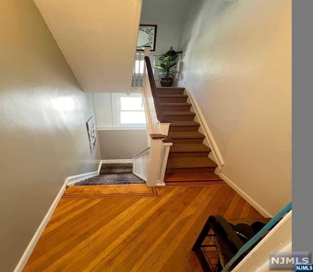 stairs featuring wood-type flooring