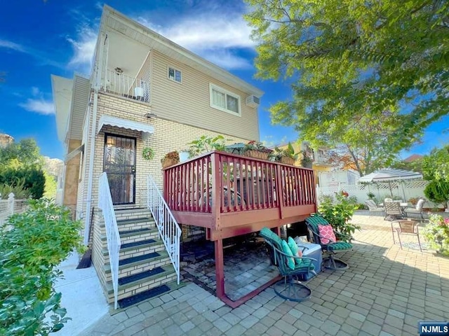 back of property with a patio area and a wooden deck