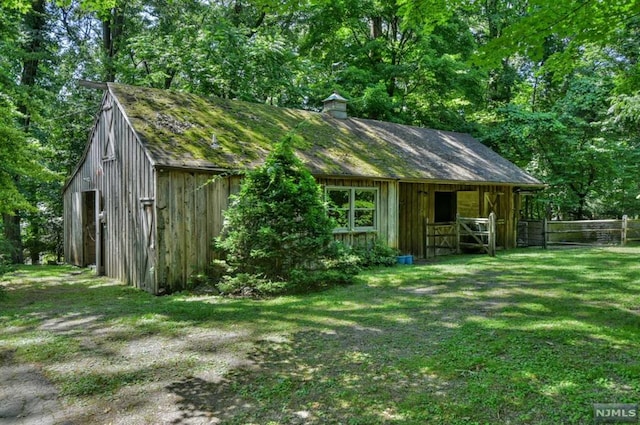 view of outdoor structure with a lawn