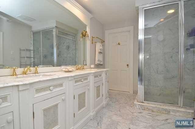 bathroom with vanity and a shower with shower door