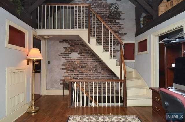 stairs with a high ceiling and hardwood / wood-style flooring