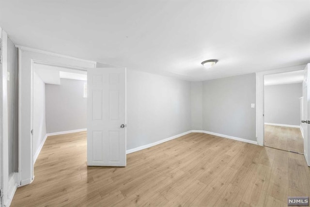 basement with light hardwood / wood-style flooring