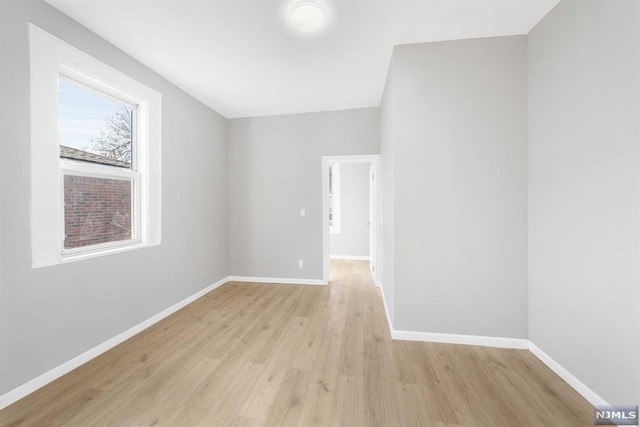 unfurnished room with light wood-type flooring