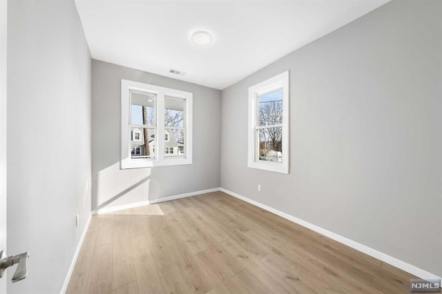 unfurnished room featuring light hardwood / wood-style floors