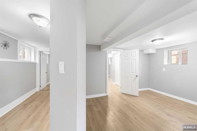 basement with light hardwood / wood-style floors