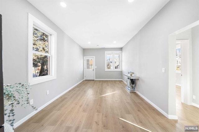 living room featuring light hardwood / wood-style floors and a wealth of natural light