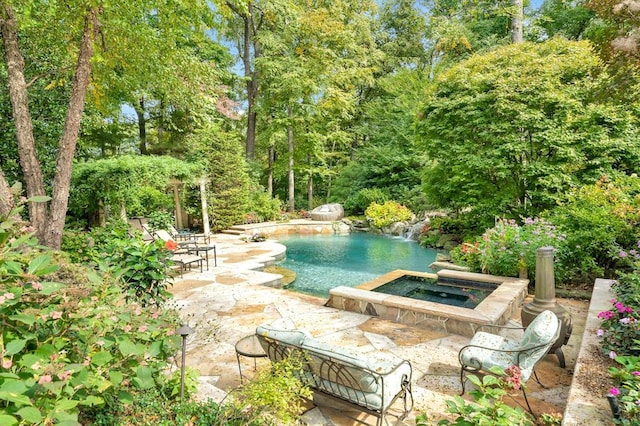 view of pool featuring an in ground hot tub and a patio