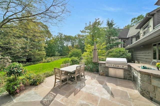 view of patio / terrace with sink, an outdoor kitchen, and a grill