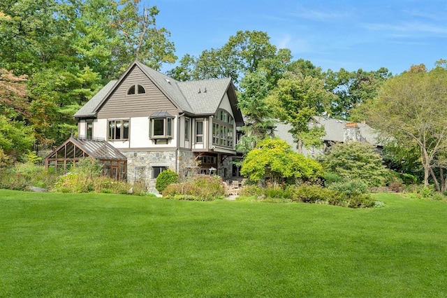 back of house with a lawn