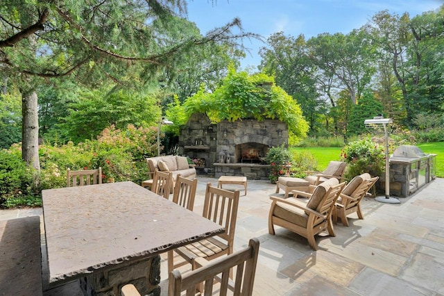 view of patio / terrace with an outdoor living space with a fireplace