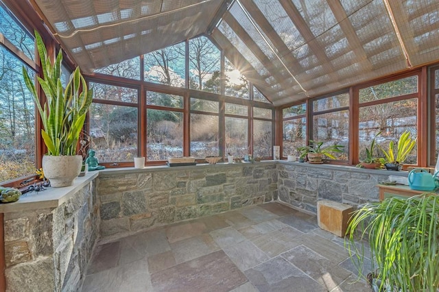 unfurnished sunroom featuring a wealth of natural light and lofted ceiling