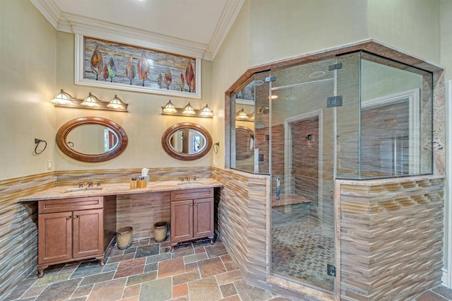 bathroom with vanity, a shower with shower door, crown molding, and tile walls