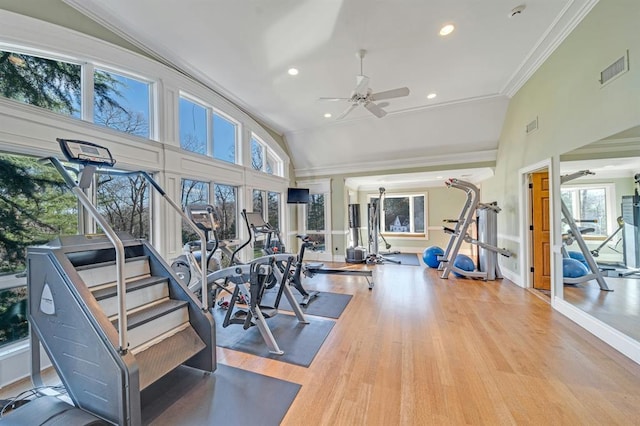 gym with hardwood / wood-style flooring, ceiling fan, crown molding, and high vaulted ceiling