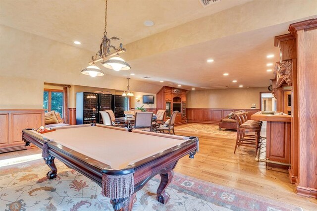 recreation room featuring a large fireplace, light hardwood / wood-style floors, and pool table