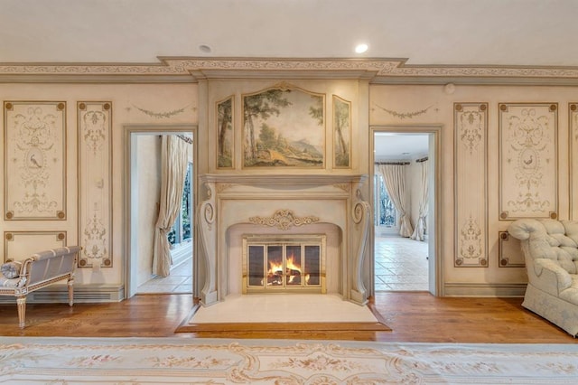 unfurnished room featuring plenty of natural light, ornamental molding, and light hardwood / wood-style flooring