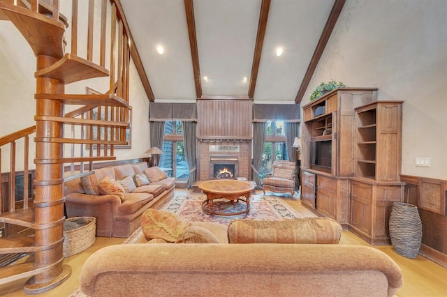 living room featuring beamed ceiling, high vaulted ceiling, and light hardwood / wood-style flooring