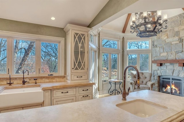 kitchen featuring vaulted ceiling with beams, plenty of natural light, and sink