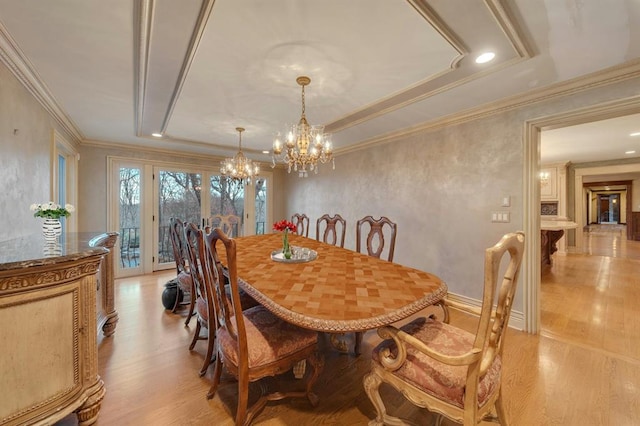 dining area featuring a chandelier, light hardwood / wood-style floors, and ornamental molding