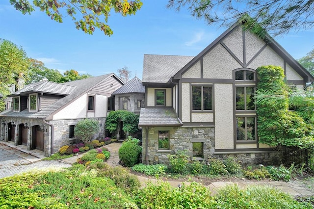 tudor-style house featuring a garage