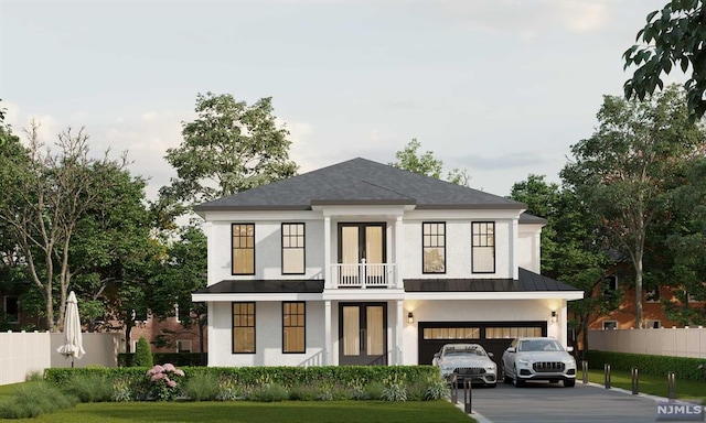 view of front of house featuring a front yard, a balcony, and a garage