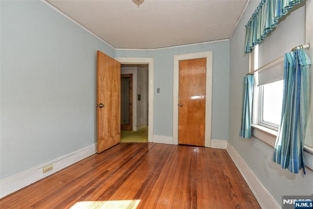 unfurnished bedroom featuring hardwood / wood-style flooring