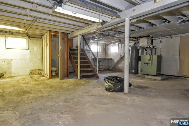 basement featuring heating unit and gas water heater