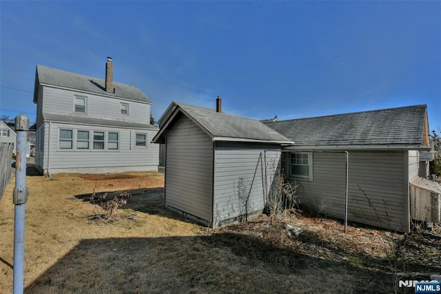 rear view of house with a yard