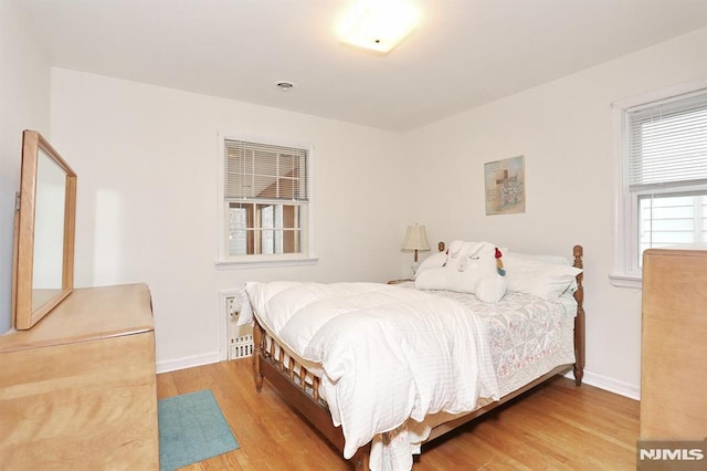 bedroom with hardwood / wood-style floors