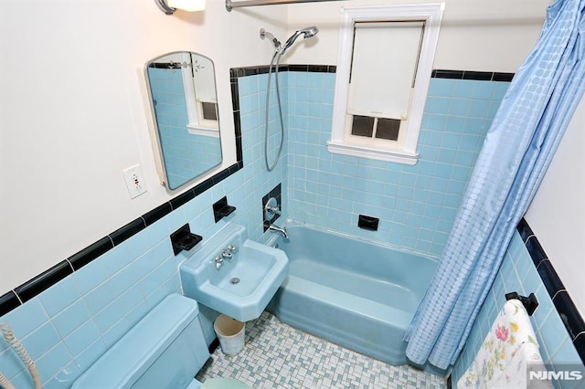 bathroom featuring sink, tile patterned floors, tile walls, and shower / bath combo with shower curtain