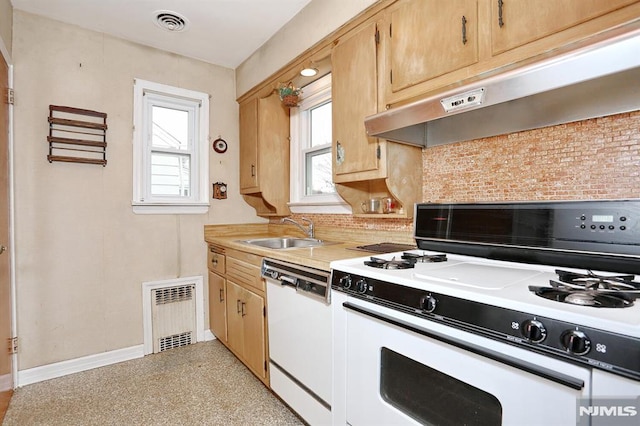 kitchen featuring sink, white appliances, decorative backsplash, and light brown cabinetry