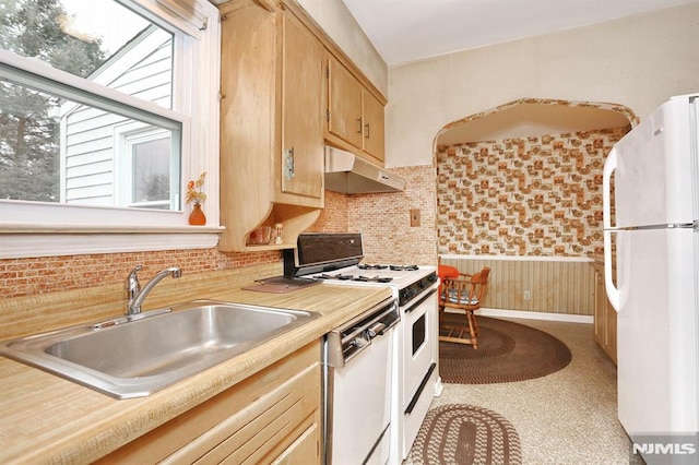 kitchen featuring white appliances, light brown cabinets, and sink