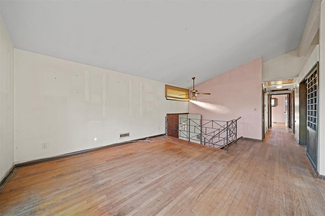 unfurnished room featuring wood-type flooring, ceiling fan, and lofted ceiling