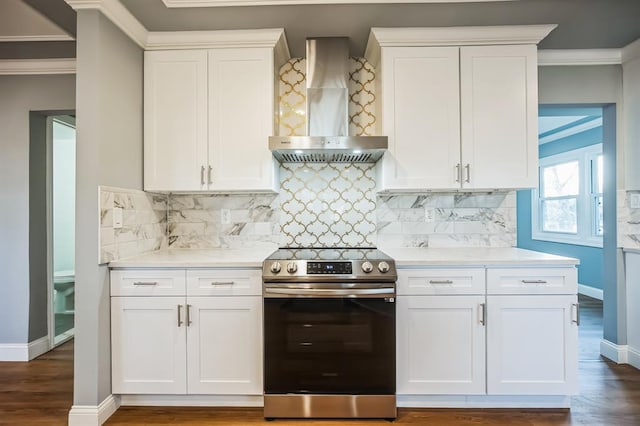 kitchen featuring electric range, dark hardwood / wood-style flooring, white cabinets, and wall chimney range hood