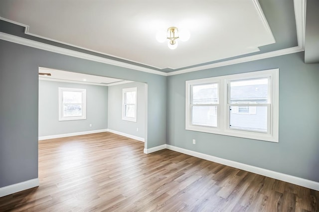 spare room with hardwood / wood-style floors and ornamental molding