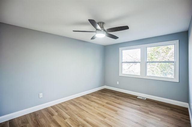 unfurnished room with ceiling fan and light wood-type flooring