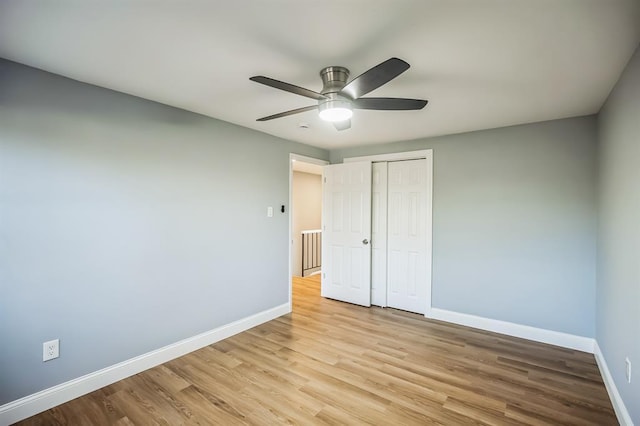 unfurnished bedroom featuring light wood-type flooring, a closet, and ceiling fan