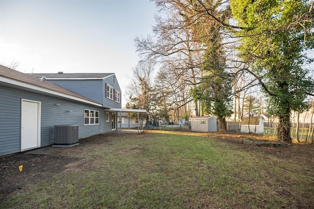 view of yard featuring central AC unit and a storage unit