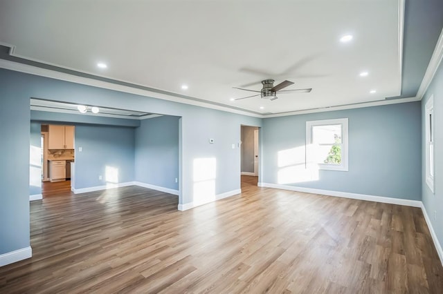 empty room with ceiling fan, light hardwood / wood-style floors, and ornamental molding