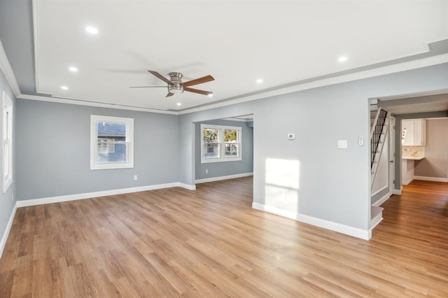 empty room featuring ceiling fan, ornamental molding, and light hardwood / wood-style flooring