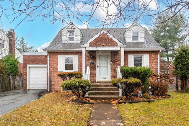 new england style home featuring a front yard and a garage