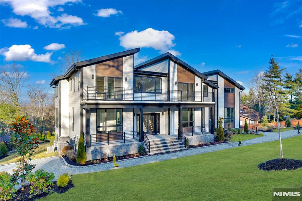 view of front of property with a balcony, a front lawn, and a porch