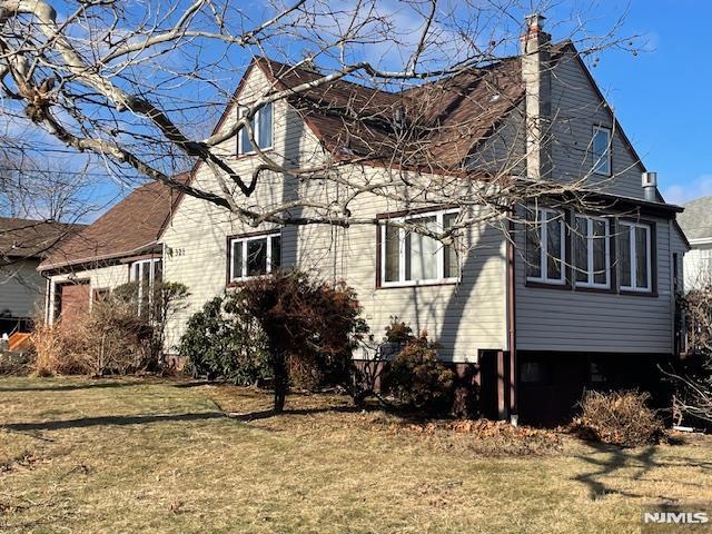 view of property exterior with a yard