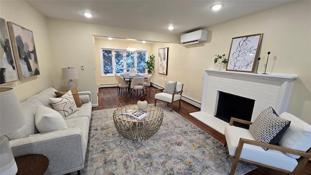 living room with a wall mounted air conditioner, dark hardwood / wood-style floors, a brick fireplace, and a baseboard radiator