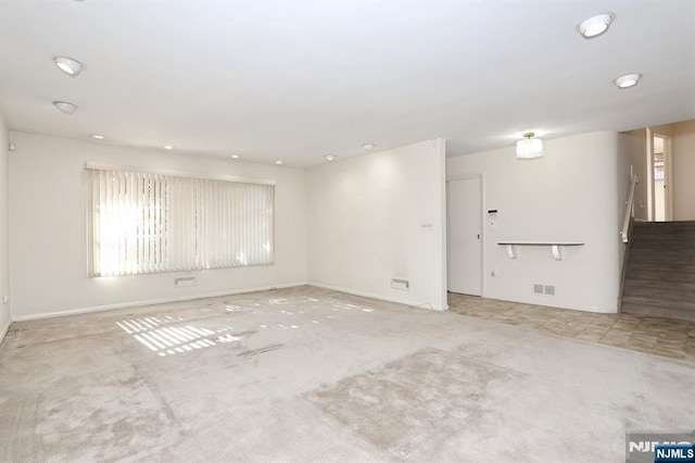 unfurnished room with light colored carpet