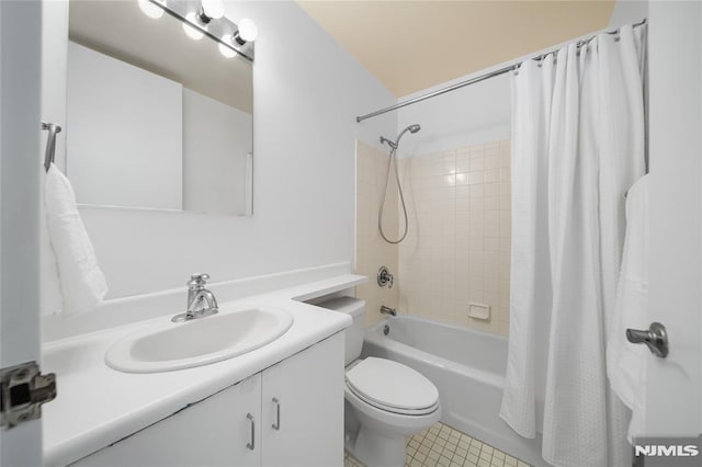 full bathroom featuring shower / bath combo, toilet, and vanity