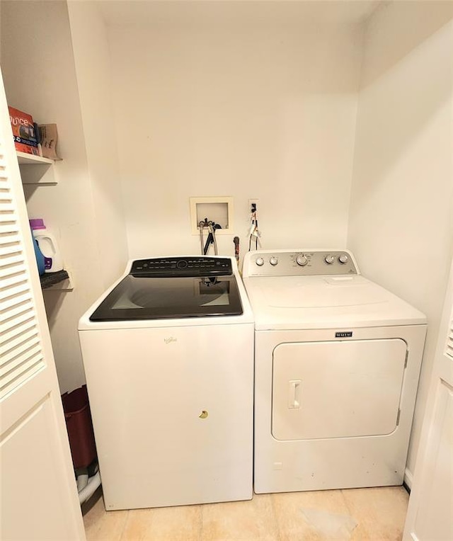 washroom with washing machine and clothes dryer