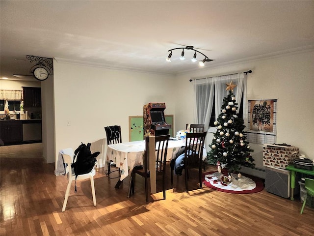 dining room featuring wood-type flooring and ornamental molding